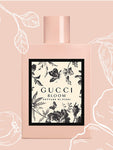 GUCCI BLOOM NETTARE DI FIORI in back, pink cap, black leaves, Pink outer layer, white coloured flowers, Pink background